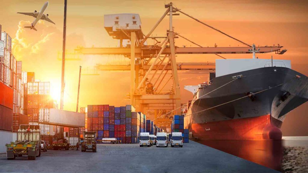 A bustling cargo port during sunset with a clear sky. The image features a large cargo ship docked at the port, with its bow prominently displayed in the foreground. Multiple stacked shipping containers in various colors are visible, indicating active trade and transportation. In the background, a crane towers over the scene, suggesting ongoing loading or unloading operations. A forklift is seen moving near the containers, and an airplane is captured mid-flight against the orange hues of the setting sun, adding to the dynamic industrial atmosphere of global commerce.